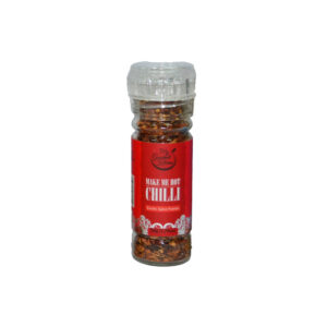 Glass spice bottle with red 'Make Me Hot Chilli' label and visible chili flakes inside, standing upright on a white background.