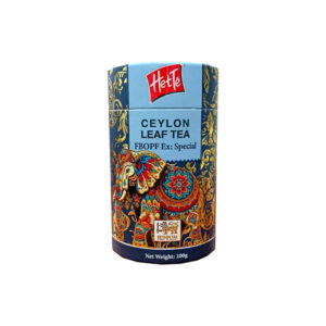 Blue decorative tea tin with ornate elephant artwork, label reads 'Ceylon Leaf Tea' and 'Net Weight: 100 g' under a red logo at the top.