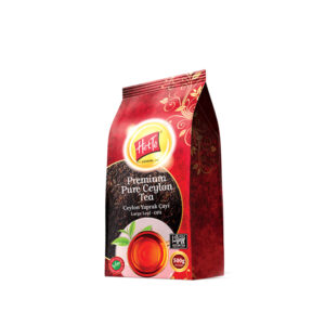 Red packaging for Het Te Premium Pure Ceylon Tea, 500 g, with decorative gold pattern and a cup of tea graphic on the front.